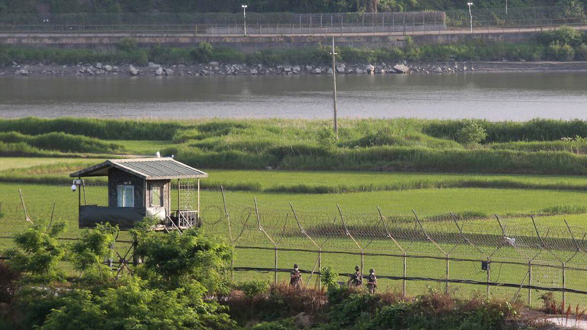 South Korean army soldiers patrol along the barbed-wire fence in Paju, South Korea, near the...