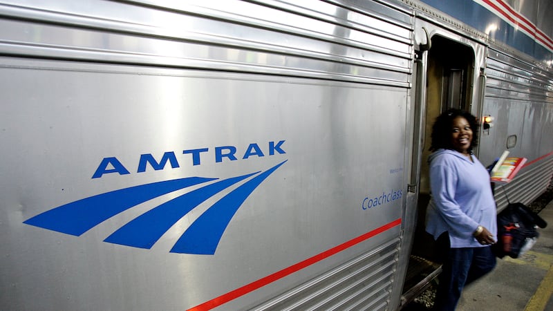 FILE - A passenger disembarks from Amtrak's Sunset Limited at its final stop in New Orleans,...