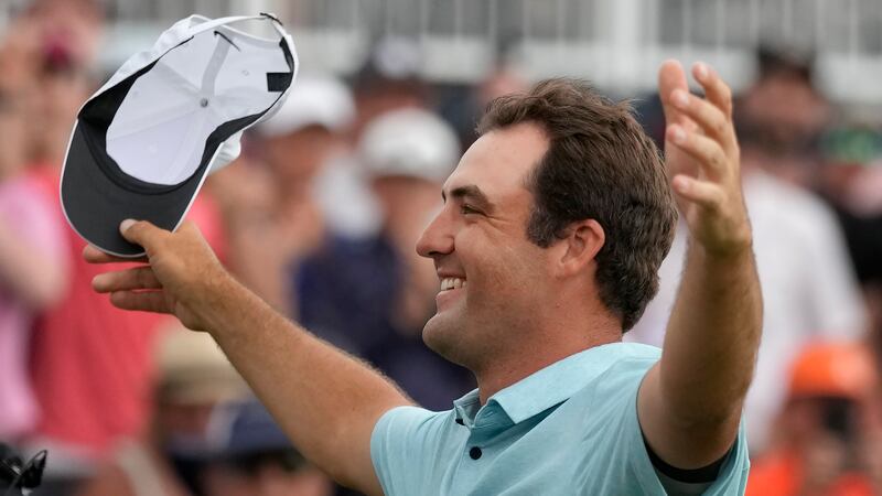 Scottie Scheffler celebrates after winning The Players Championship golf tournament, Sunday,...