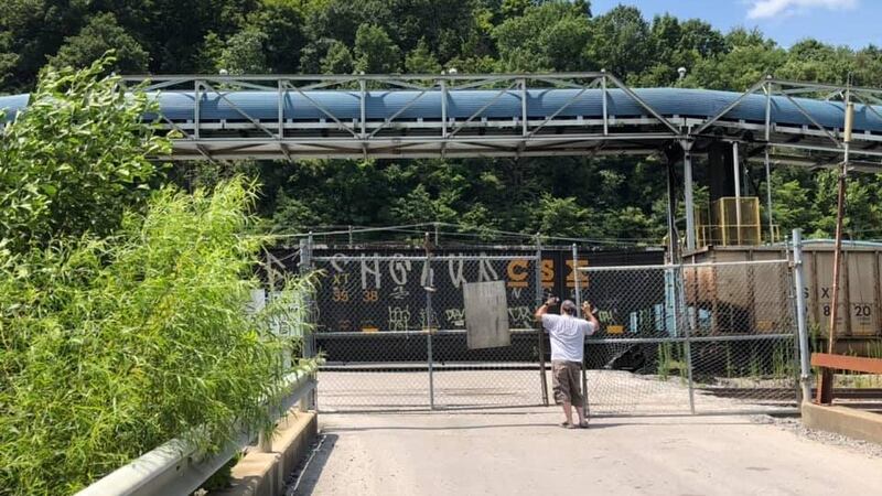 A miner looks on as a train hauls coal away from Cloverlick Mine 1. Blackjewel miners have not...