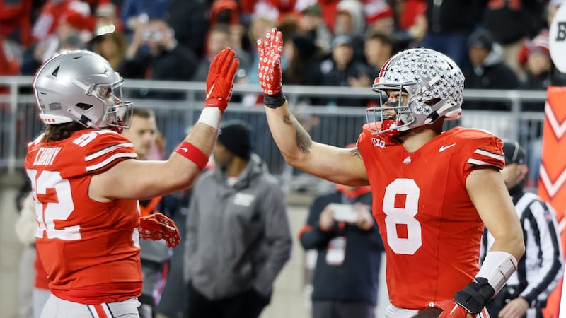 Ohio State tight end Cade Stover, right, celebrates after his touchdown against Minnesota with...