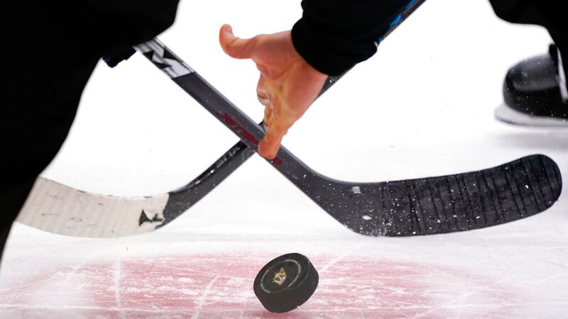 The puck is dropped during a face-off in the third period of an NHL hockey game between the...