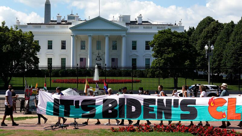 FILE - Climate activists rally in front of the White House at Lafayette Square to demand that...